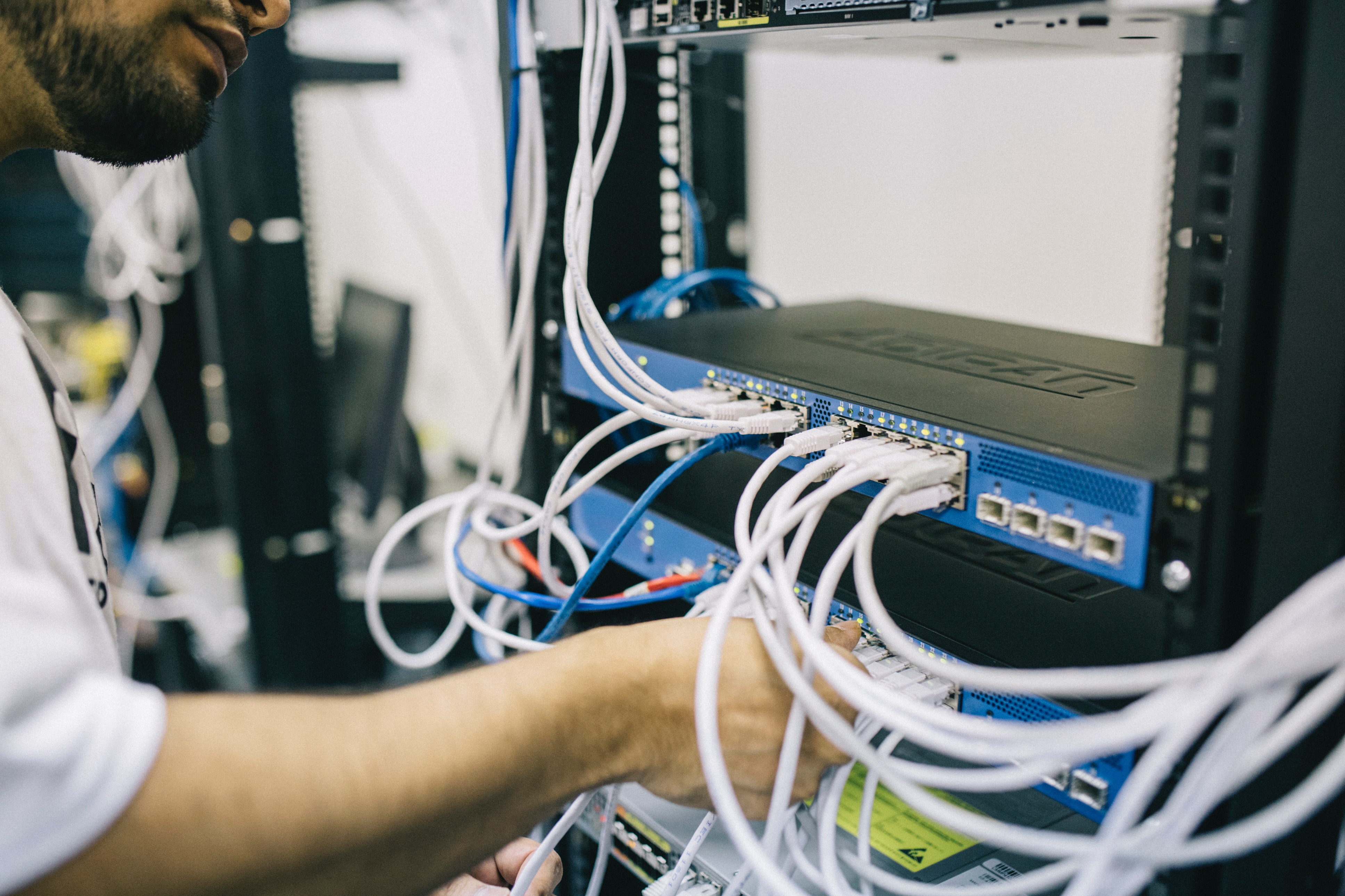 Photo of a Field Engineer fixing cables on a Server